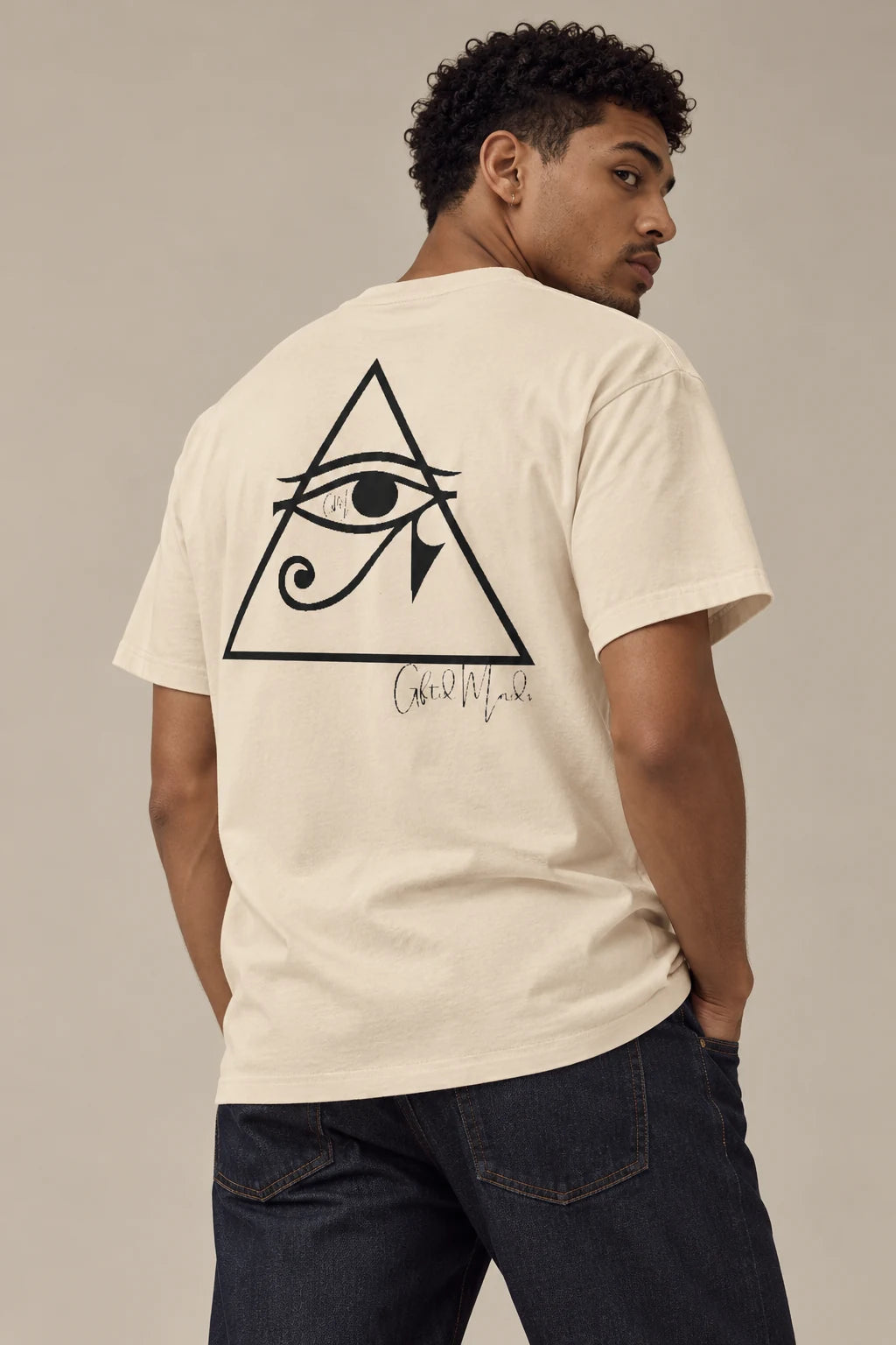 Back print of the soft cream Eye of Horus tee on a fictional model